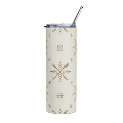 Cream tumbler with repeating brown snowflake pattern and metal straw.