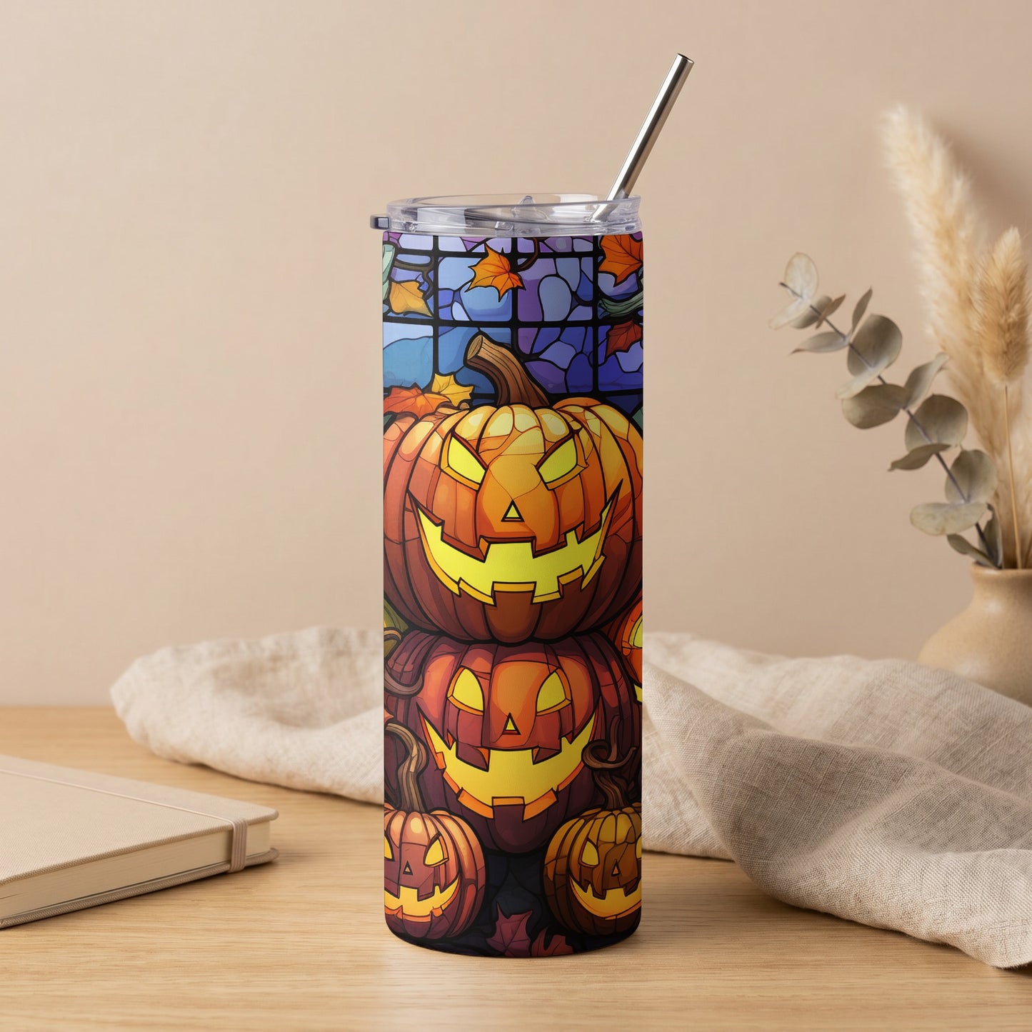 Tall tumbler with carved jack-o'-lanterns and stained glass pattern.