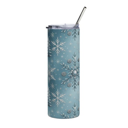 Blue tumbler with silver snowflakes, trees, and circular ornaments, metal straw.