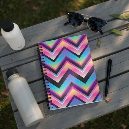Spiral notebook with colorful chevron pattern and two water bottles and sunglasses.