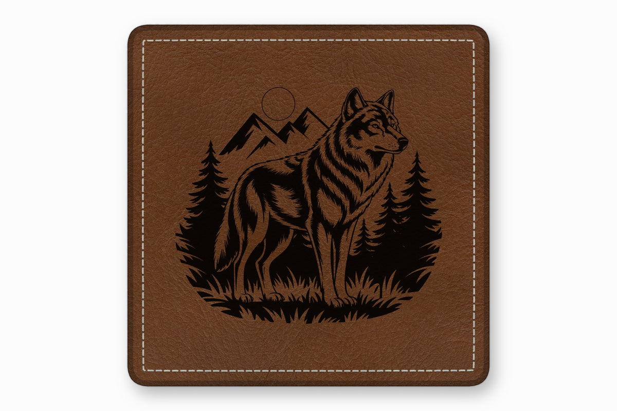 Square brown leather patch with white stitched border, featuring a black engraved wolf wilderness design.