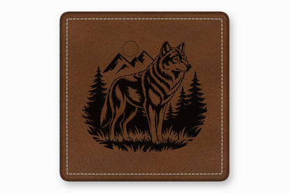 Square brown leather patch with white stitched border, featuring a black engraved wolf wilderness design.