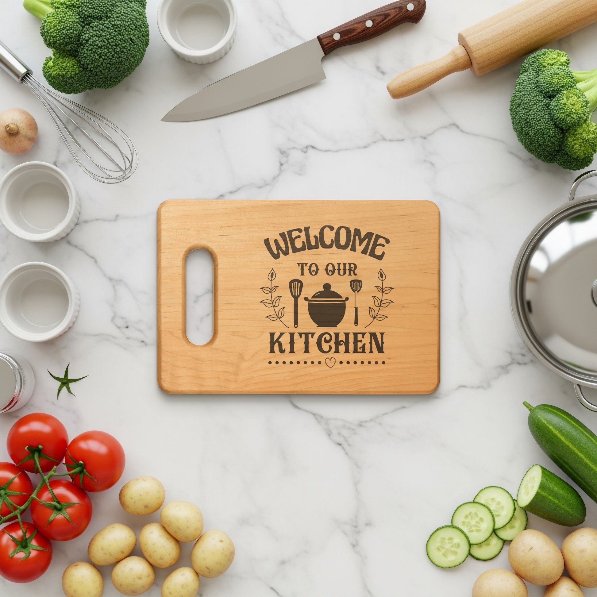 Wooden cutting board with "Welcome to Our Kitchen" engraved text and kitchen scene.