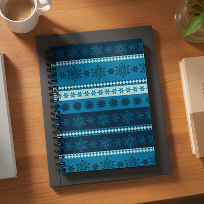 Spiral notebook with blue and white snowflake patterned cover.