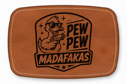 Brown leather patch with rounded corners and white stitching, featuring a laser-engraved duck holding a gun and text that reads PEW PEW MADAFAKAS.