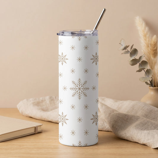 White tumbler with gold snowflake pattern and metal straw.