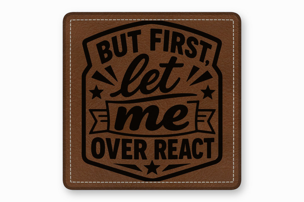 Square brown leather patch with white stitched border and the engraved text But First Let Me Overreact.