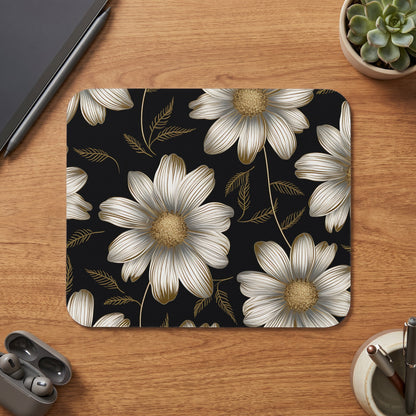 Mousepad with a black background and a white and gold floral pattern.