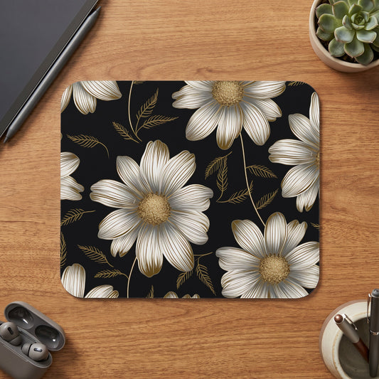 Mousepad with a black background and a white and gold floral pattern.