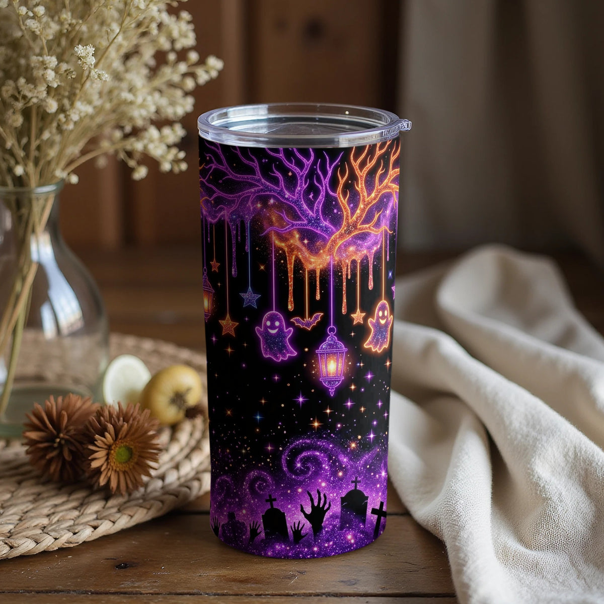 Tumbler with purple and orange galaxy tree, ghosts, bats, lanterns, and graveyard scene.