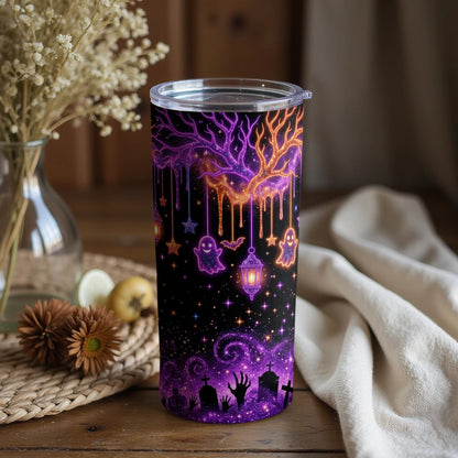 Tumbler with purple and orange galaxy tree, ghosts, bats, lanterns, and graveyard scene.