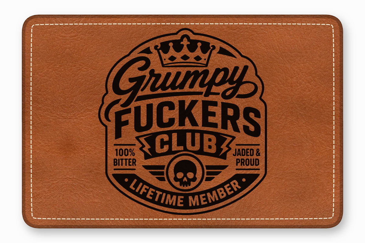 Brown leather patch with rounded corners featuring a black logo reading Grumpy Fuckers Club with a skull and crown.