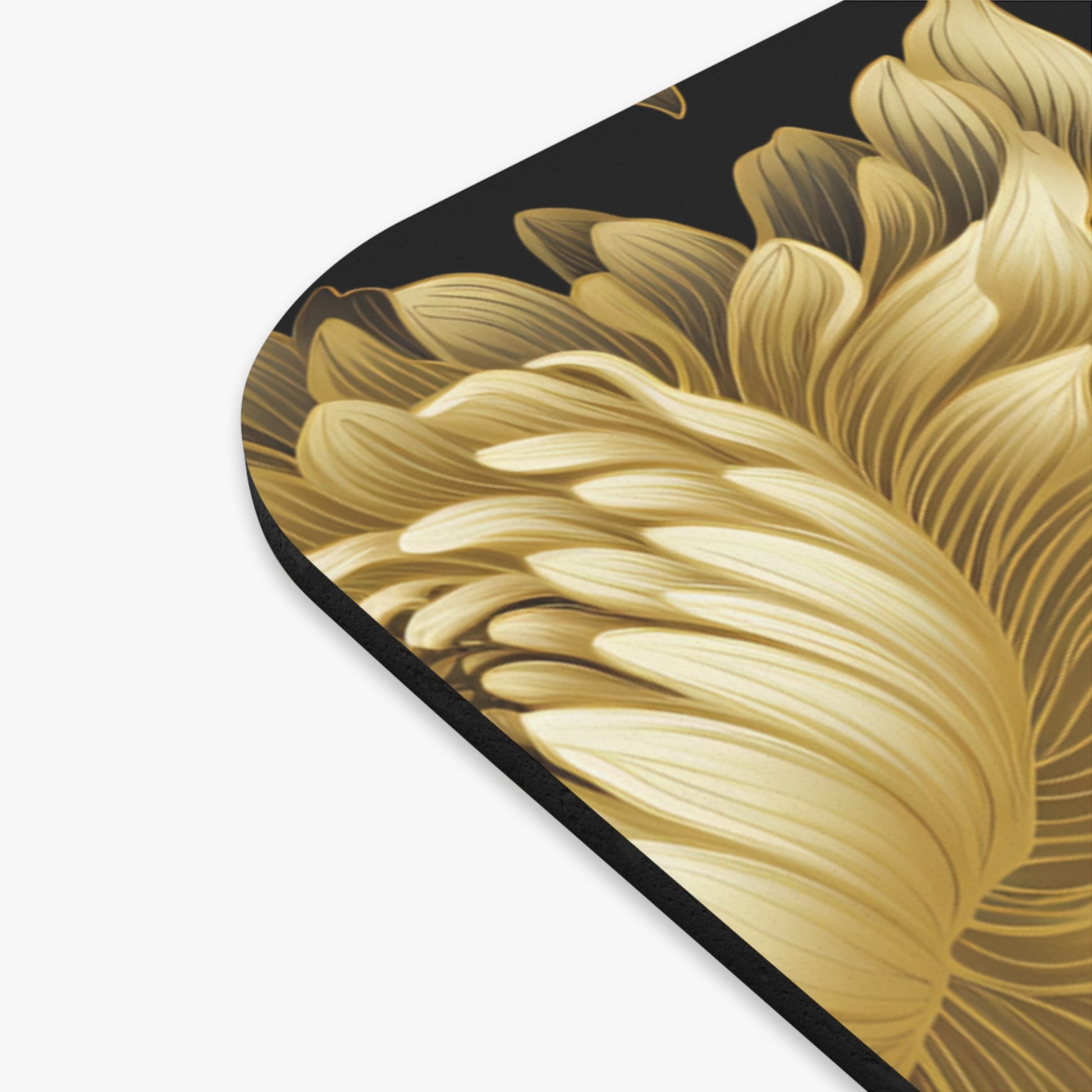 Close up of a gold floral pattern on a black background, showing detailed petal textures.