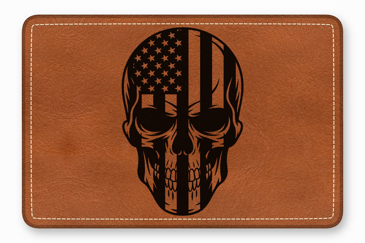 Brown leather patch with rounded corners featuring a black engraved skull and US flag design.