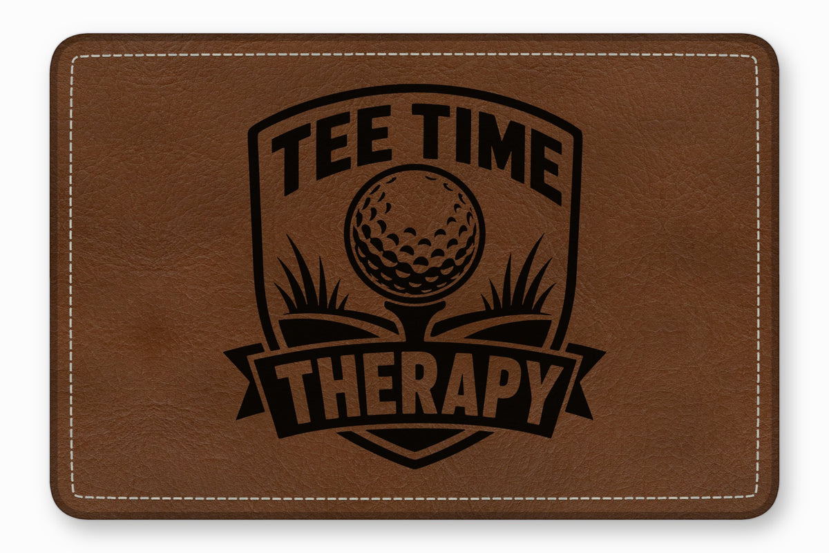 Brown leather patch with rounded corners featuring a black golf shield graphic and the text Tee Time Therapy.