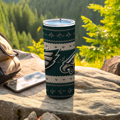 Philadelphia Eagles tumbler with a knit pattern and logo on rocks.
