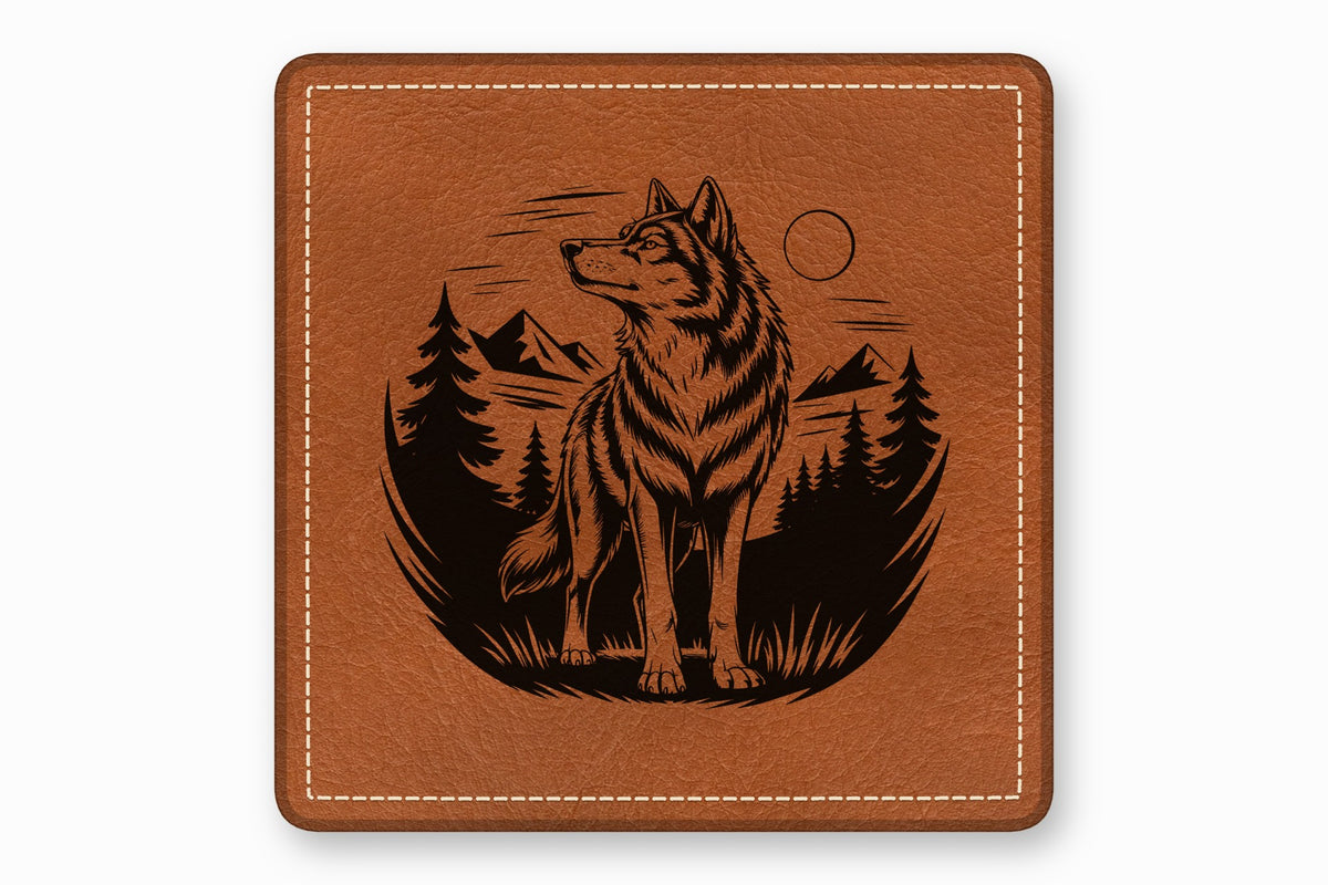 Brown square leather patch with white stitched border and laser-engraved wolf and forest design.