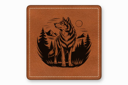 Brown square leather patch with white stitched border and laser-engraved wolf and forest design.