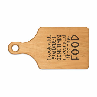 Wooden cutting board with engraved text "I cook with wine. Sometimes I even add it to the food."