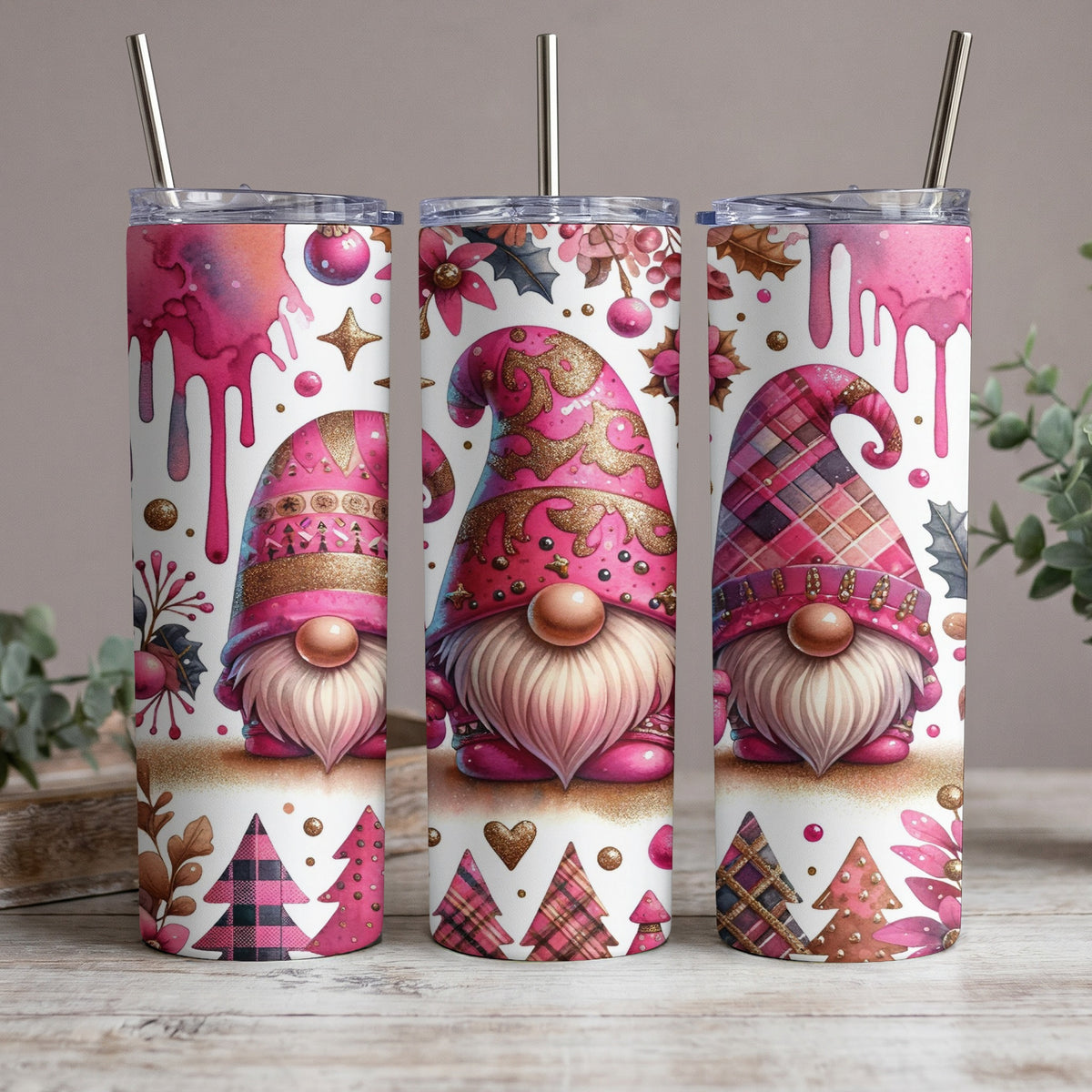 Three pink gnomes with glittery hats on tumblers with festive holiday patterns.