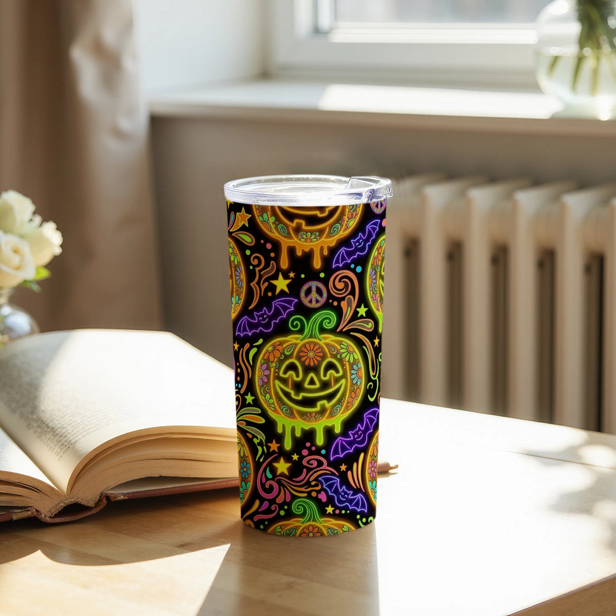 Tumbler with a black background and neon Halloween pattern featuring pumpkins and bats.