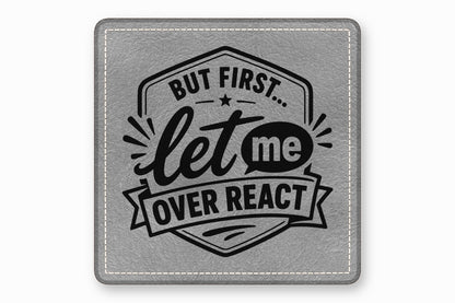 Square grey faux leather coaster with rounded corners, white stitched border, and black text reading But first let me overreact.