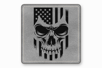A square grey leather patch features a black graphic of a skull overlaid with an American flag.