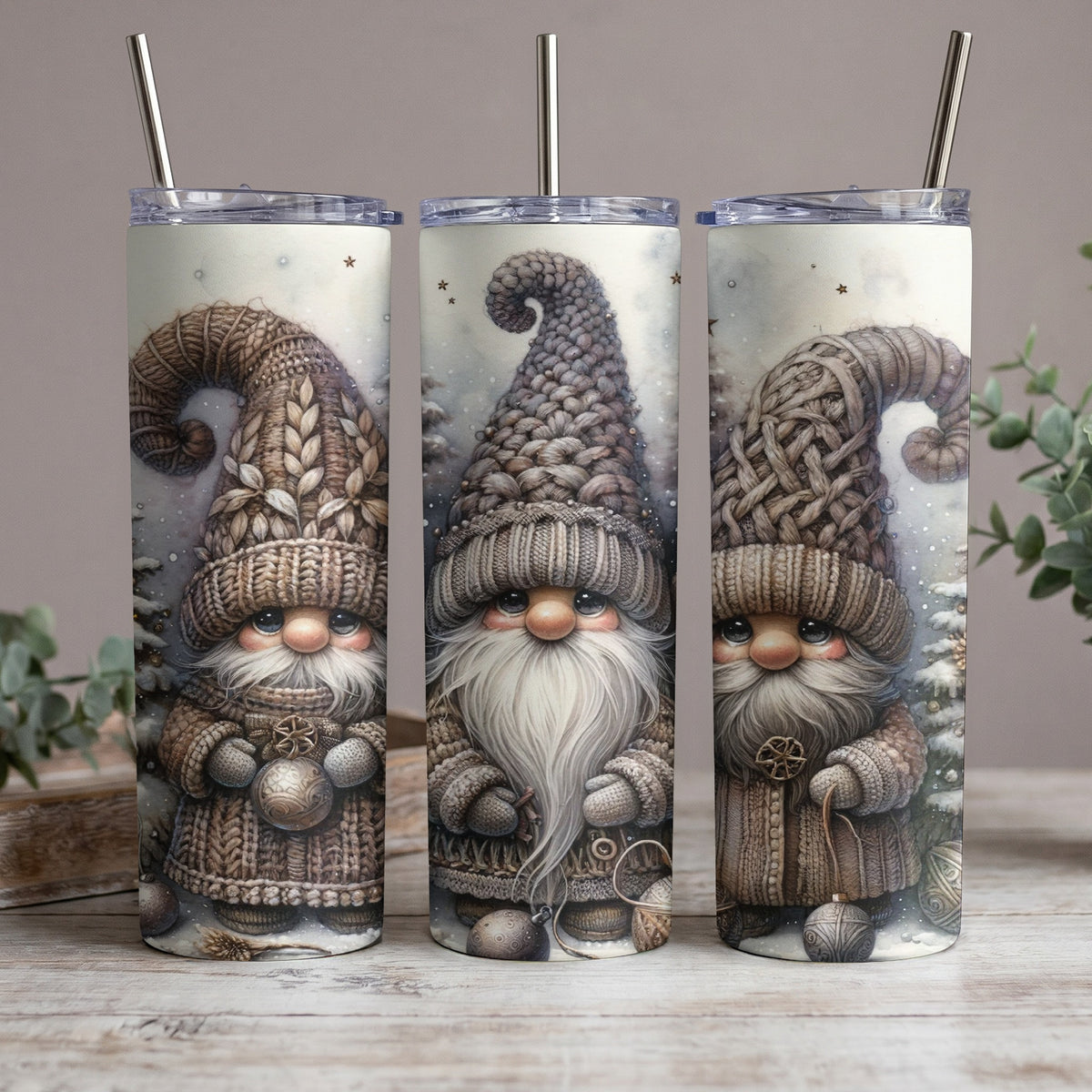 Three tumblers with winter gnome art, wearing knitted hats and sweaters.