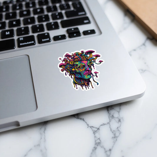 Colorful psychedelic Medusa head sticker with mushrooms on a laptop keyboard.