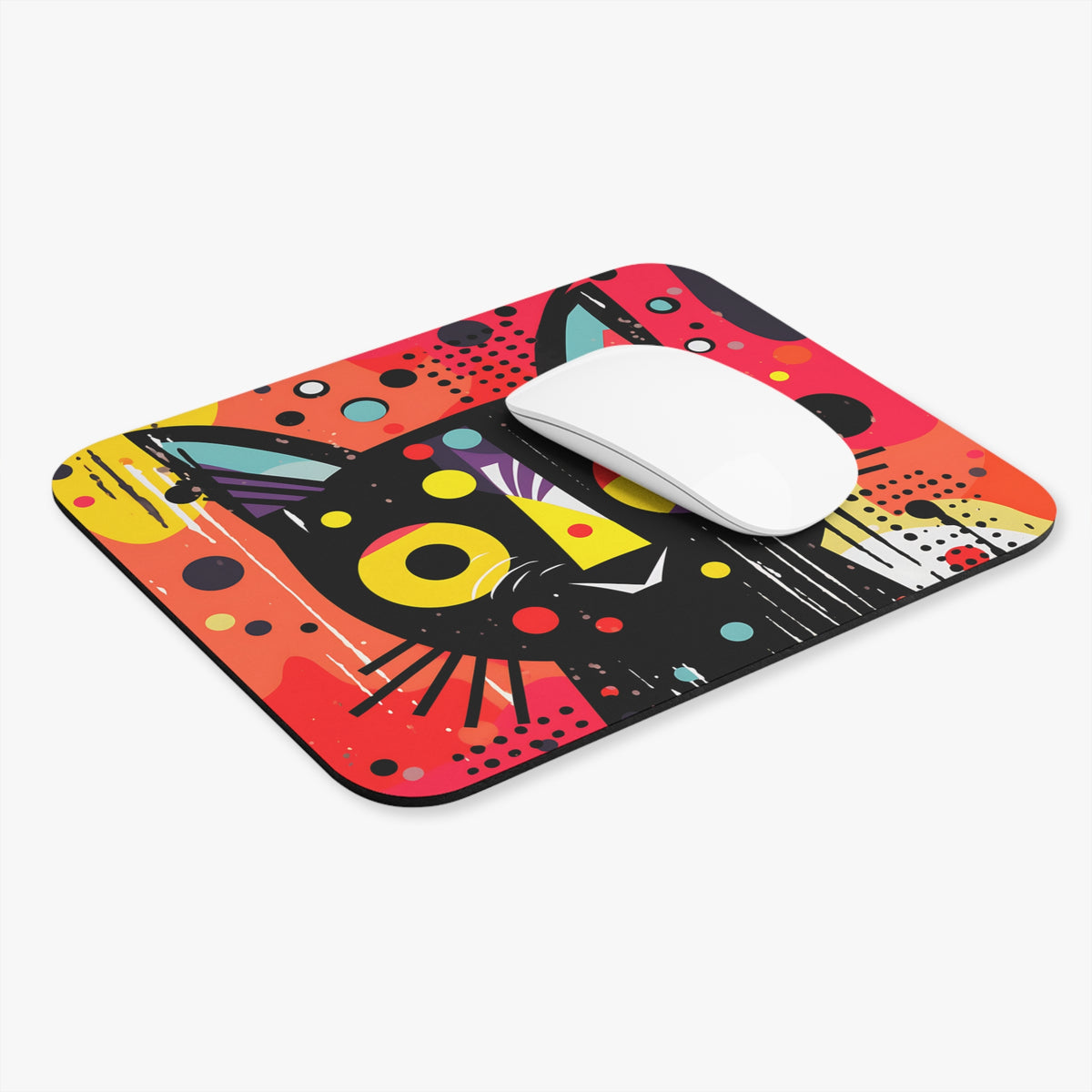 Abstract cat face design on a black and red mousepad with a white mouse.