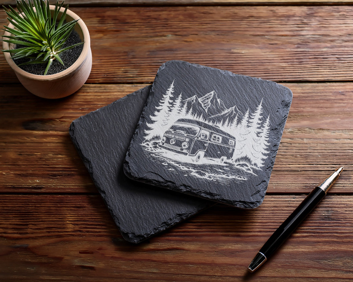 Slate coasters with etched camper van, trees, and mountains design.