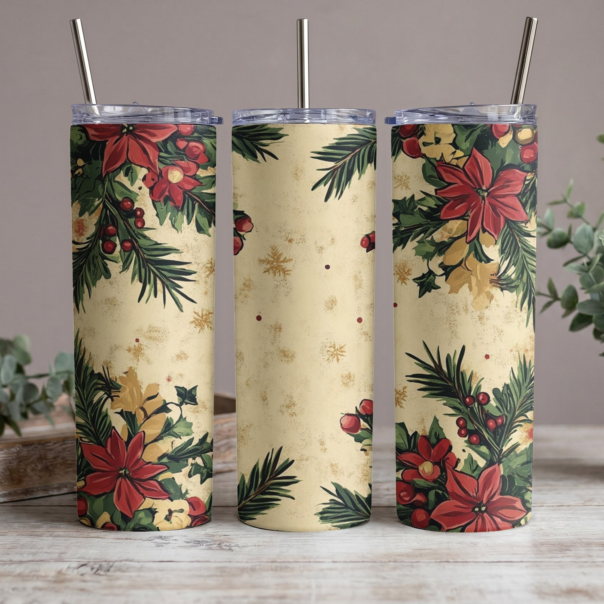 Three tumblers with Christmas poinsettia and holly design, metal straws.