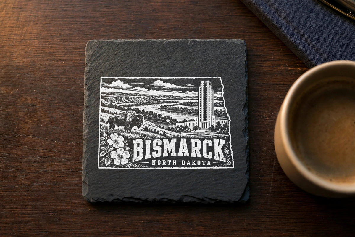 Square black slate coaster engraved with a detailed Bismarck, North Dakota landscape design.