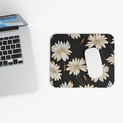Mousepad with white and gold floral pattern next to laptop and white mouse.