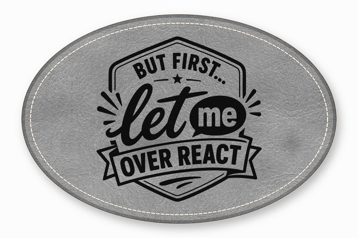An oval gray faux leather patch featuring the black text But First Let Me Over React.