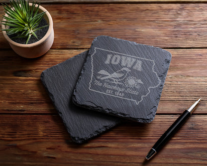 Slate coasters with etched Iowa outline, bird, sunflower, and text.