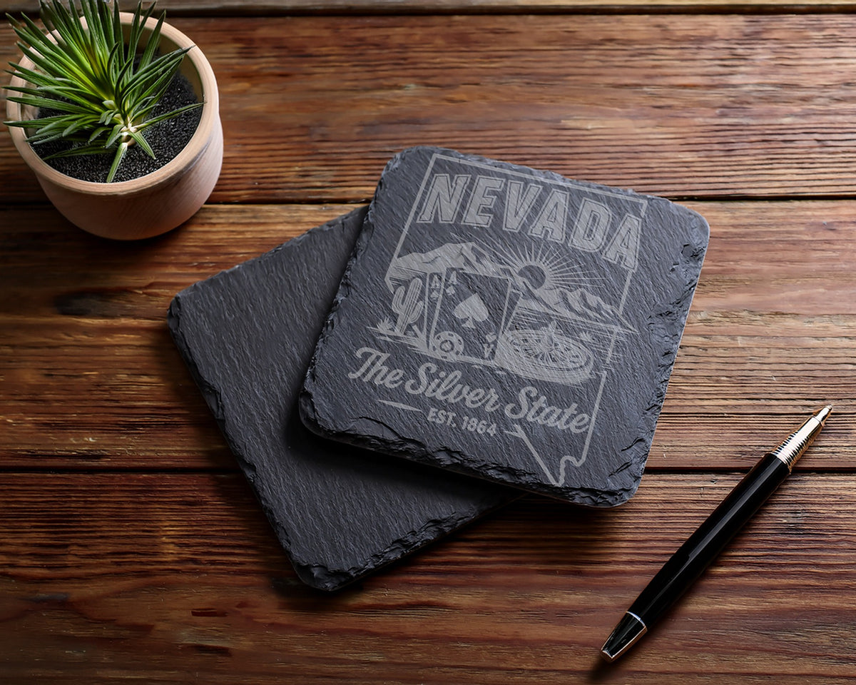 Engraved slate coaster with Nevada "The Silver State" design, cactus, mountains, and cards.