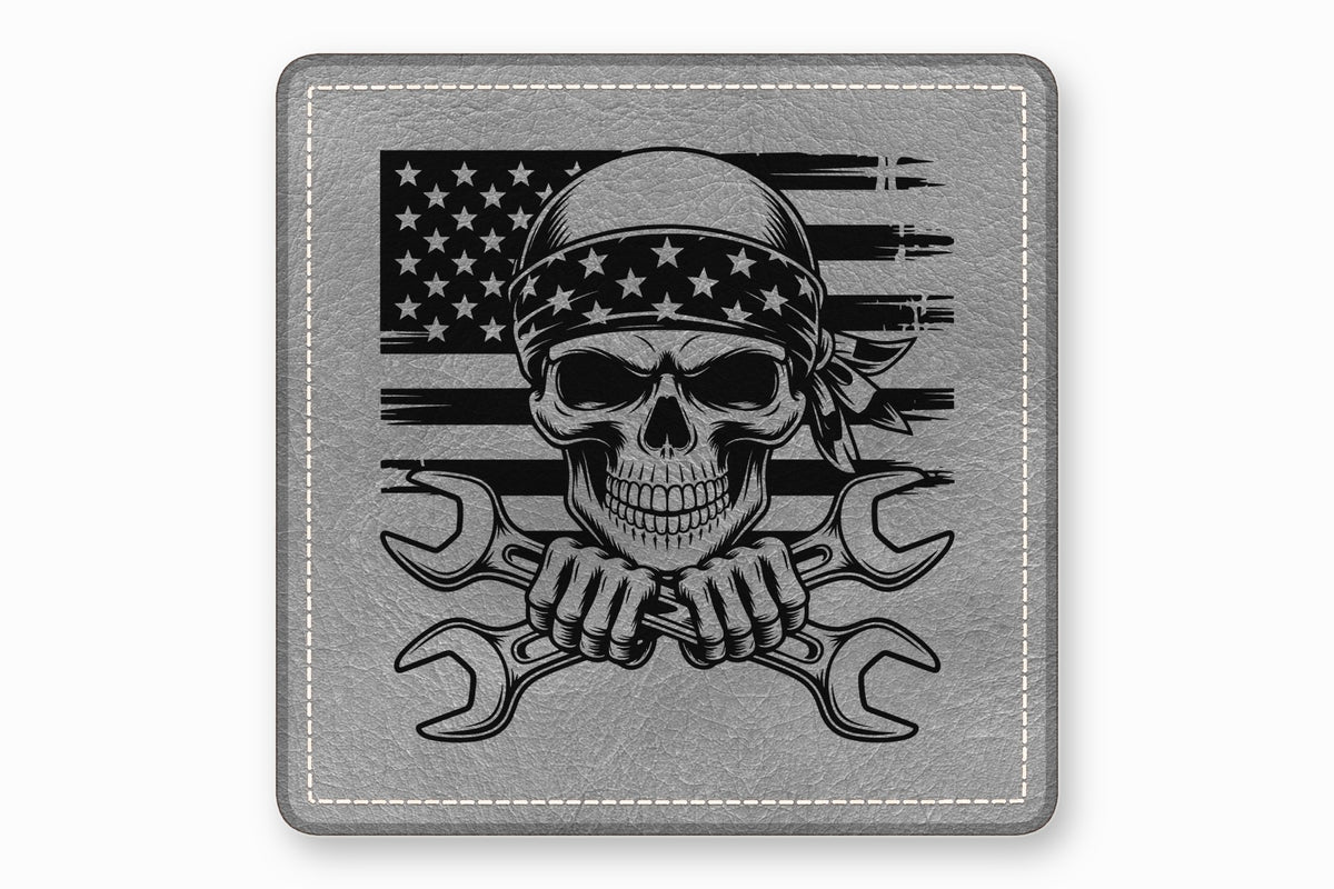 Gray leather patch featuring a skull wearing a star-patterned bandana over a distressed American flag with crossed wrenches.