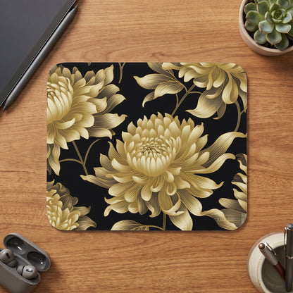 Gold chrysanthemum floral pattern on black mousepad with stylus, earbuds, and pens.