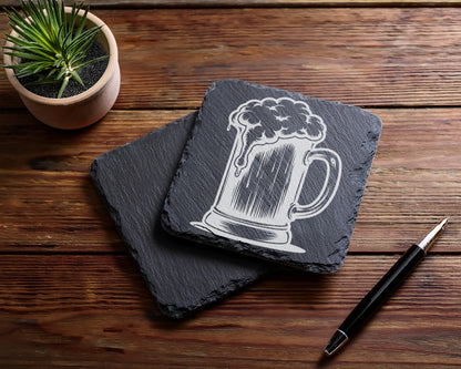 Slate coasters with etched beer mug design and a black pen.