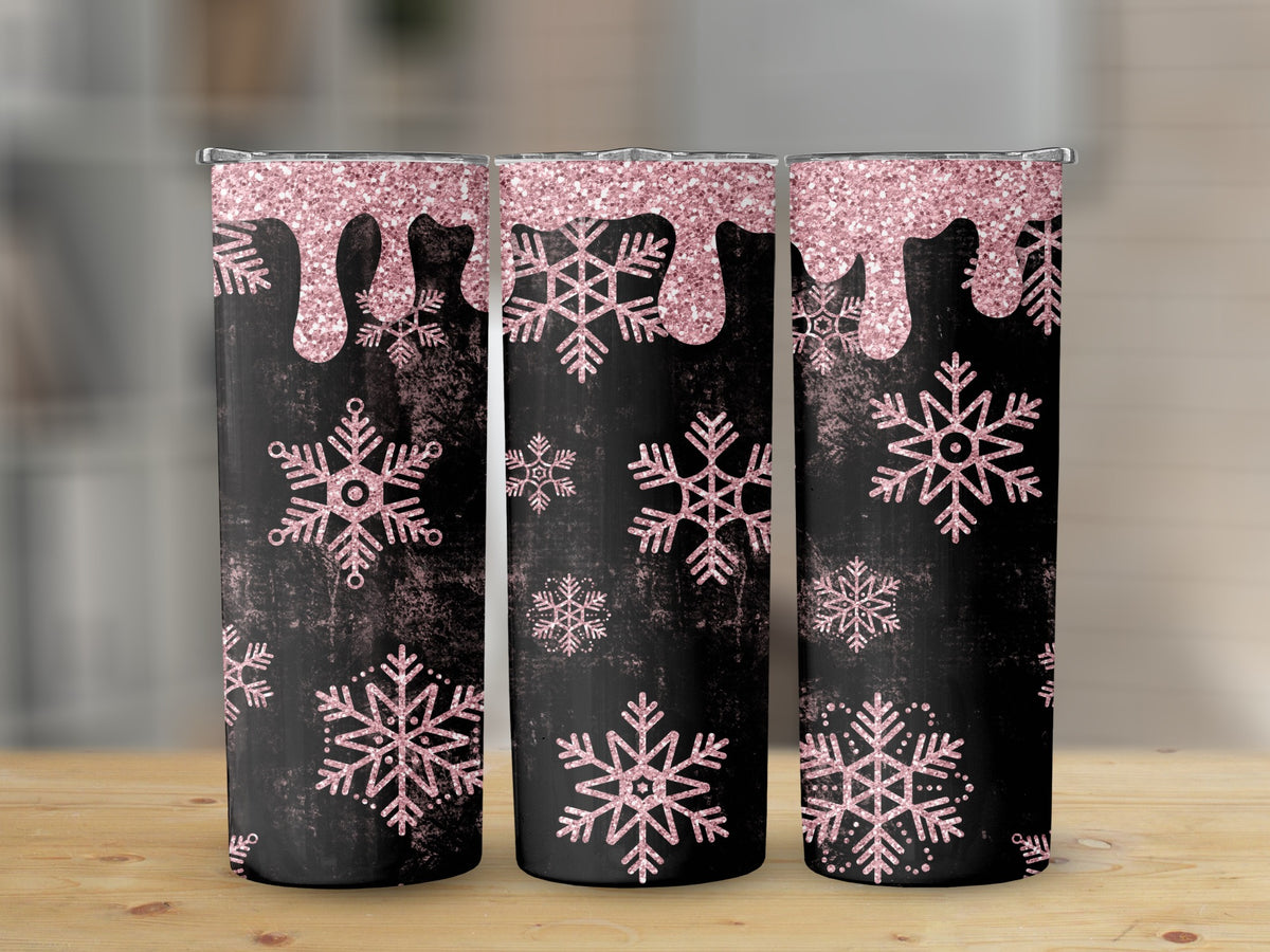 Three tumblers with black distressed background and pink glitter snowflakes.