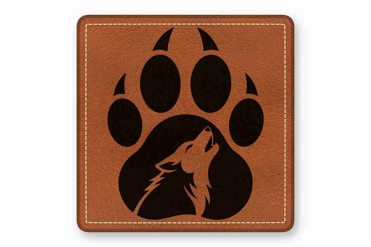 A square brown leather patch with white stitching featuring a black paw print enclosing a howling wolf silhouette.