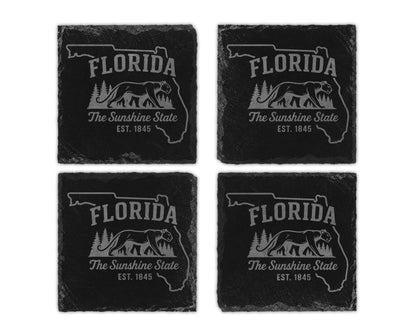 Four slate coasters feature the outline of Florida, text, and a panther illustration.