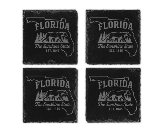 Four slate coasters feature the outline of Florida, text, and a panther illustration.