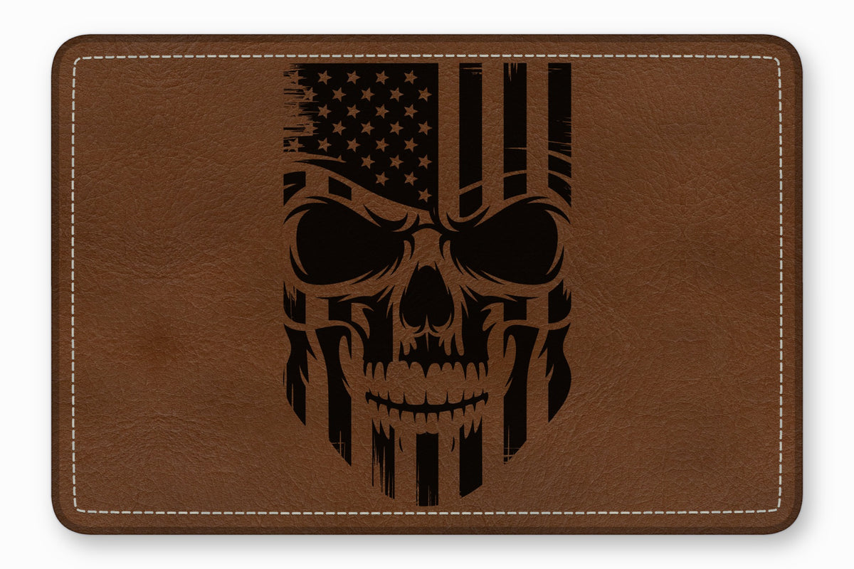 Rectangular brown leather patch featuring a distressed black American flag skull graphic and white stitching.