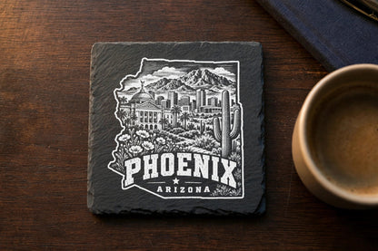 A square slate coaster engraved with a detailed Phoenix, Arizona skyline and desert landscape illustration.