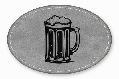 An oval gray leather patch featuring a black embroidered beer mug design.