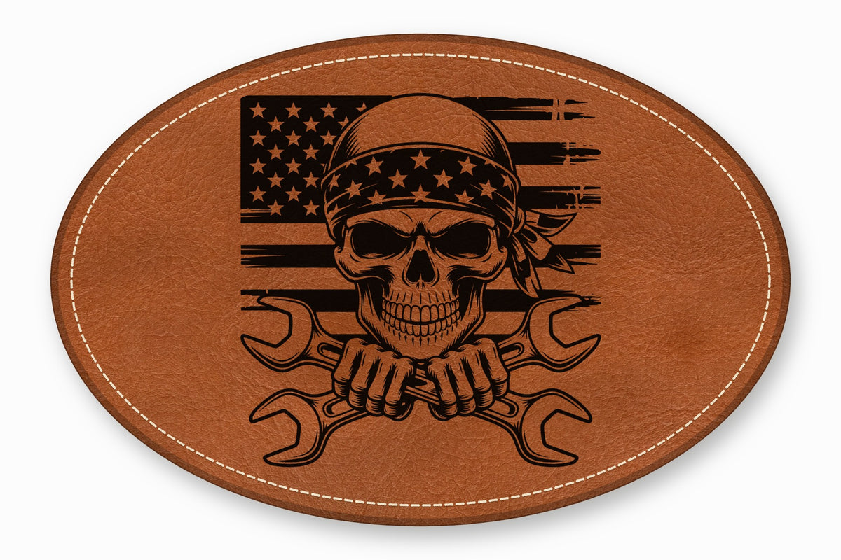 Oval brown leather patch featuring a skull in a bandana and crossed wrenches over an American flag.