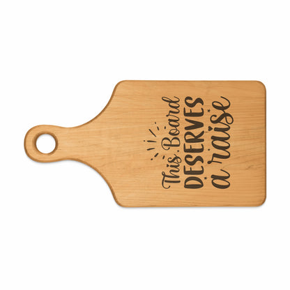 Wooden cutting board with engraved text "This Board DESERVES a raise".