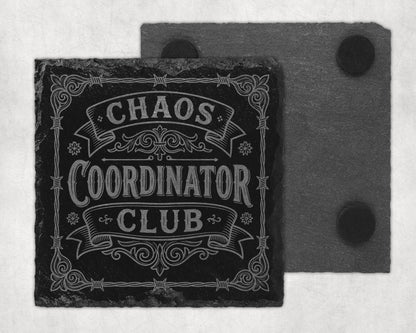 Black slate coaster engraved with "Chaos Coordinator Club" in decorative font.